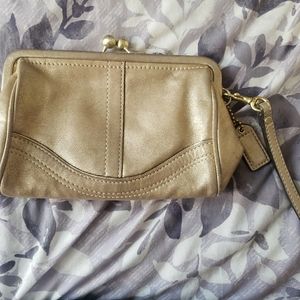 COACH Gold wristlet with clasp closure